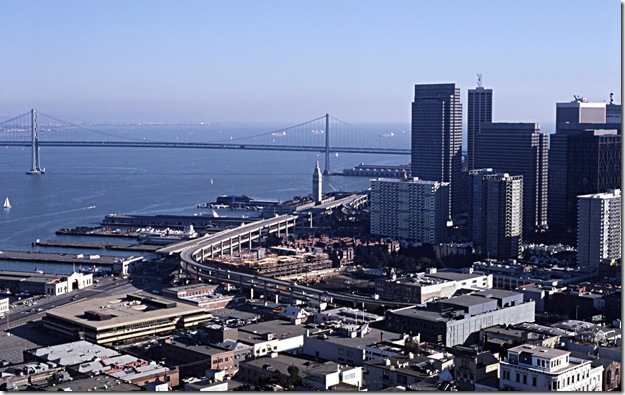 Foreground:  Embarcadero Skyway.  Center:  Ferry Building.  Left Rear:  Bay Bridge.  Right:  Northern portion of downtown San Francisco.  From Coit Tower, I think.